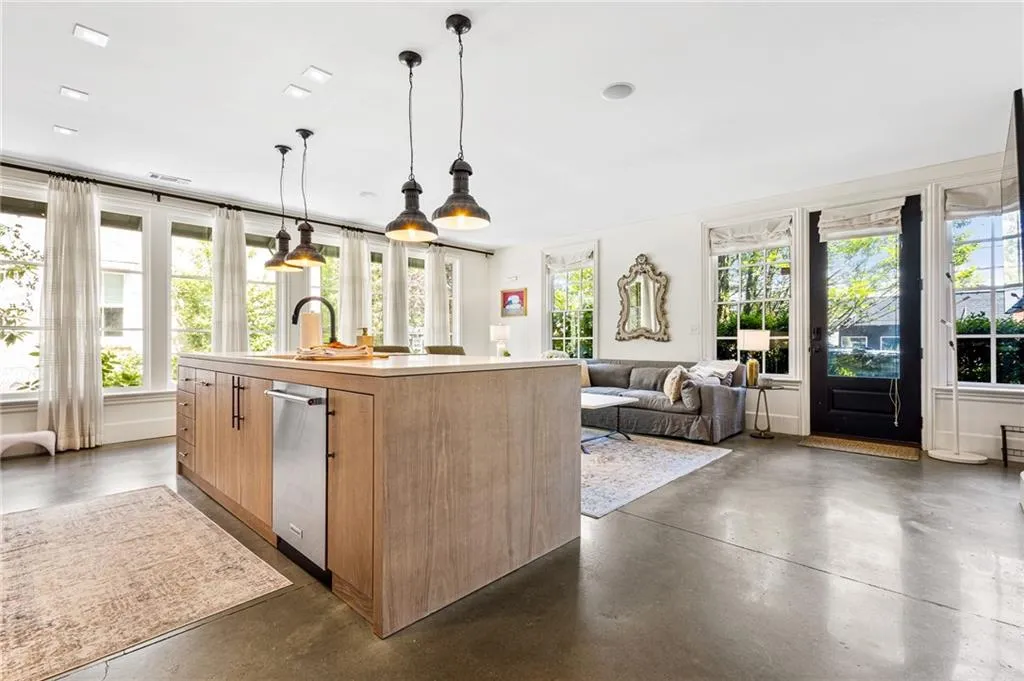 Kitchen with plenty of natural light, concrete flooring, and a sink