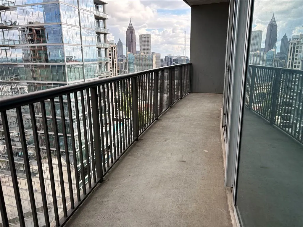 Balcony Off Living Area featuring a skyline view