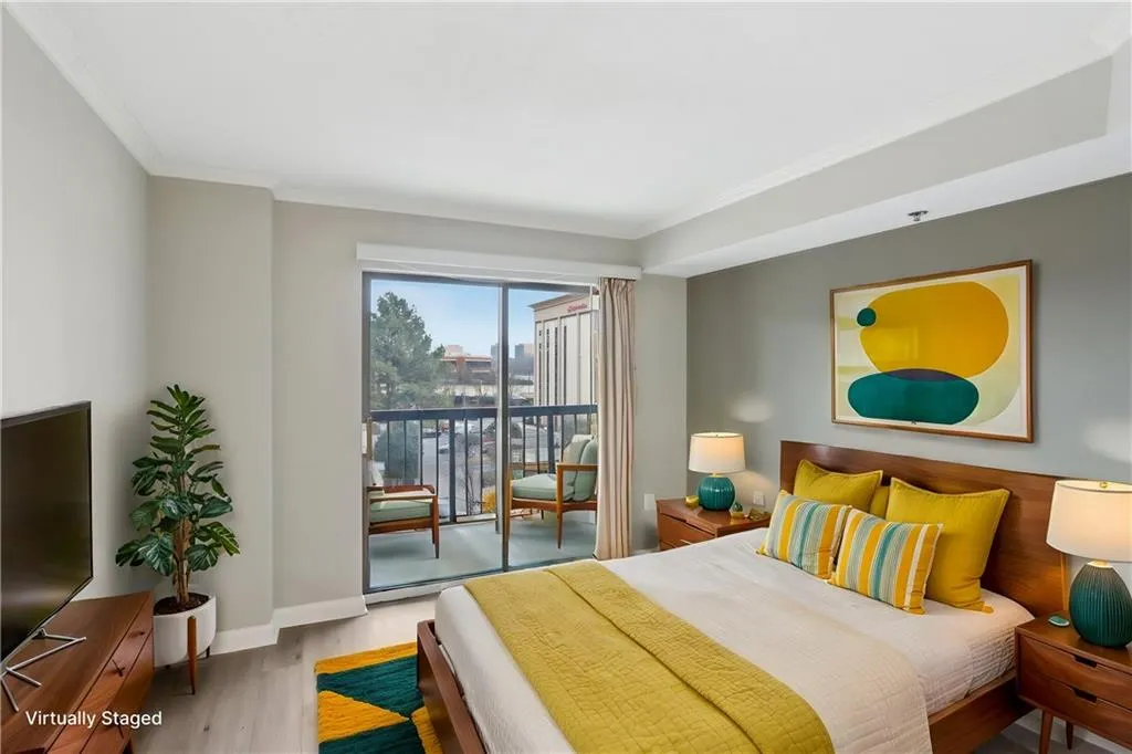 Bedroom with access to exterior, crown molding, and light hardwood / wood-style floors