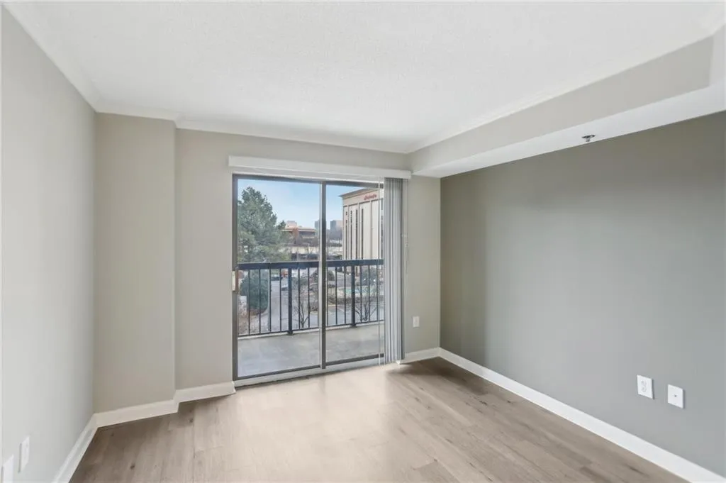 Unfurnished room with ornamental molding and light hardwood / wood-style floors