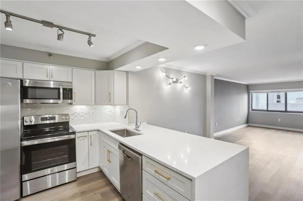Kitchen with stainless steel appliances, kitchen peninsula, and sink