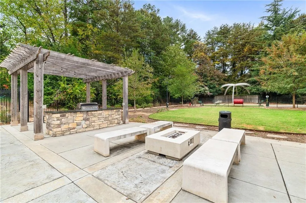 Community outdoor area with pergolas, and an outdoor fire pit
