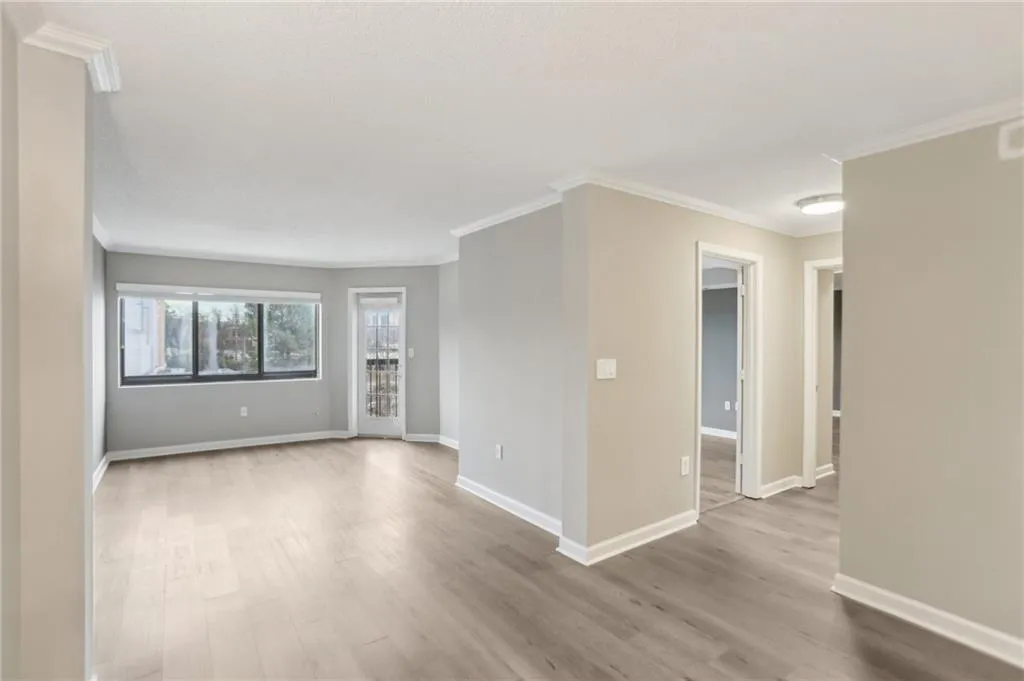 Unfurnished room featuring crown molding and light wood-type flooring