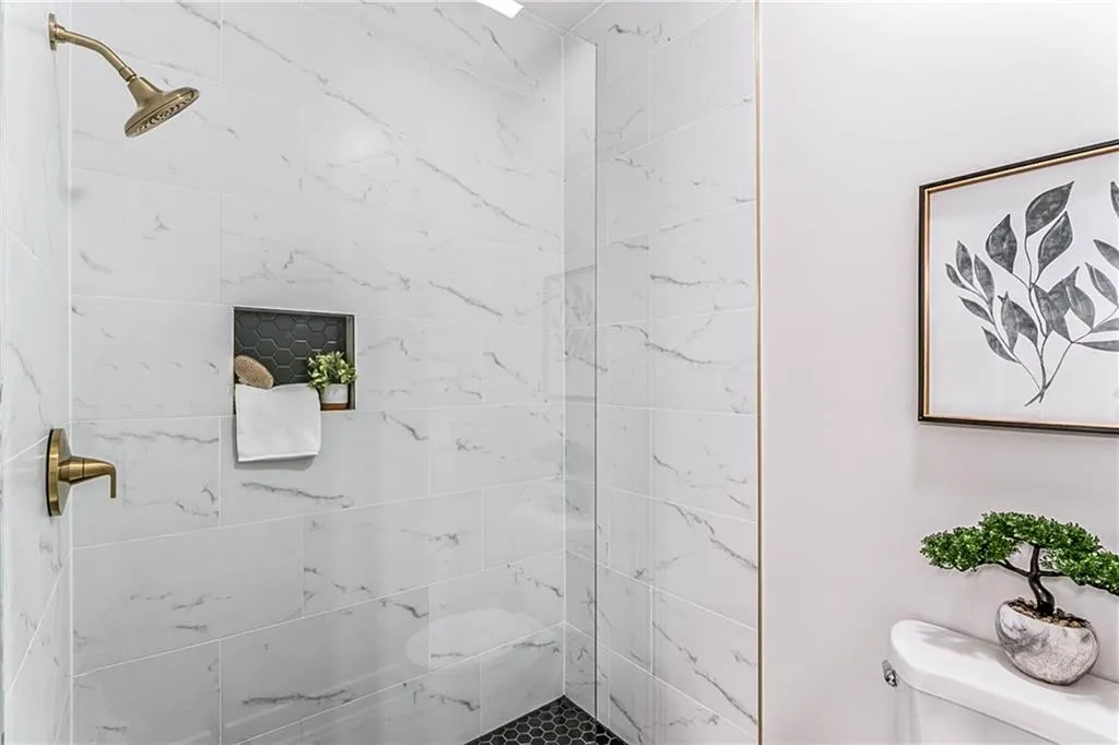 Bathroom featuring a stall shower and toilet
