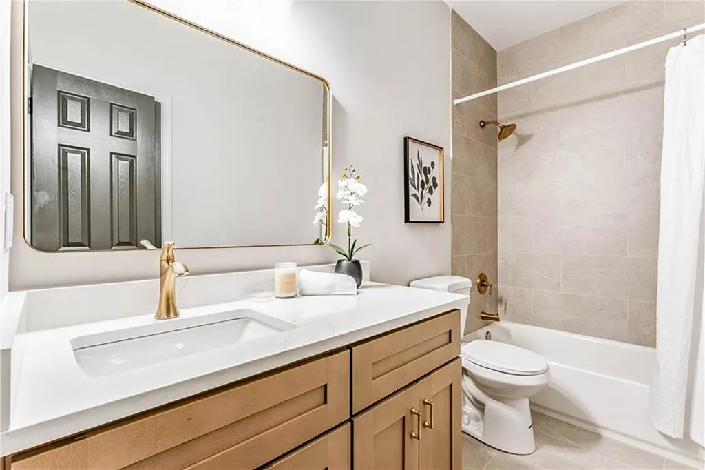 Full bathroom featuring shower / tub combo, vanity, and light tile patterned flooring