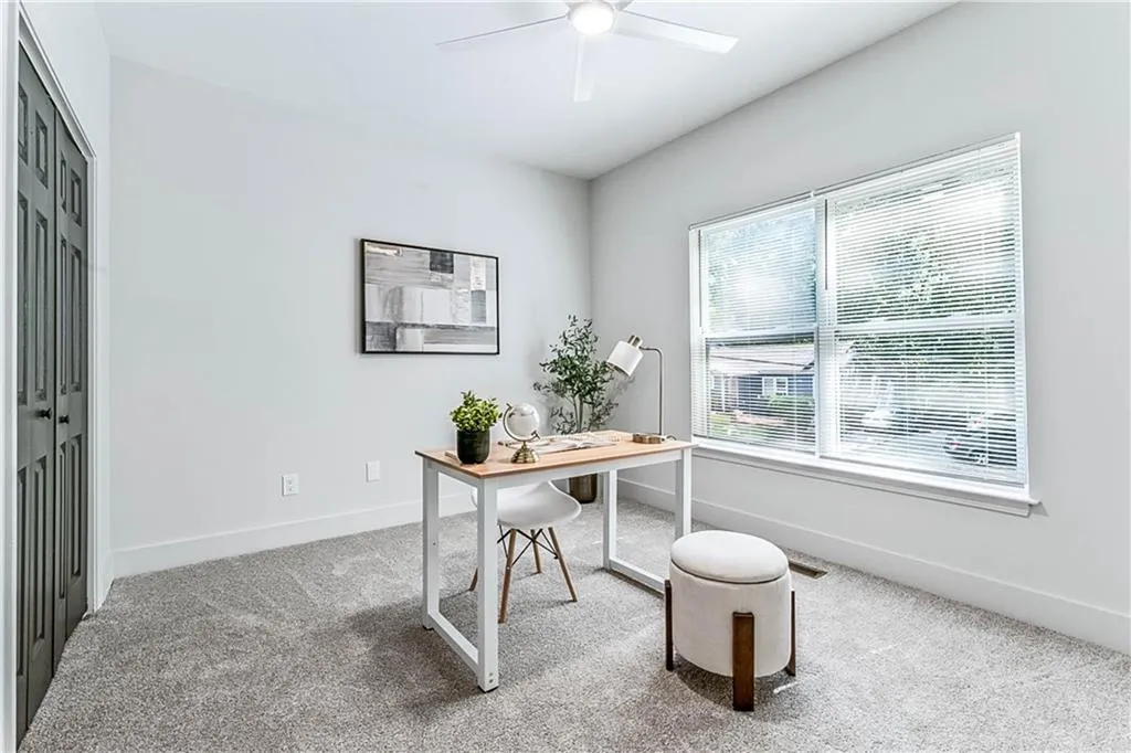 Office featuring light carpet and a ceiling fan