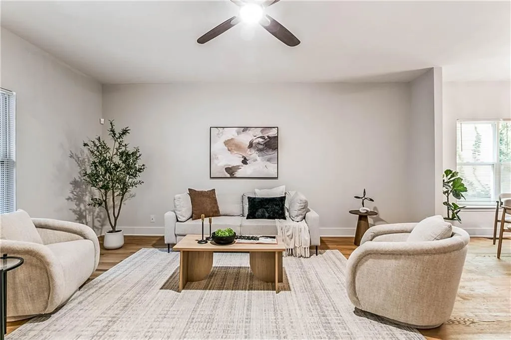 Living room featuring wood finished floors and a ceiling fan