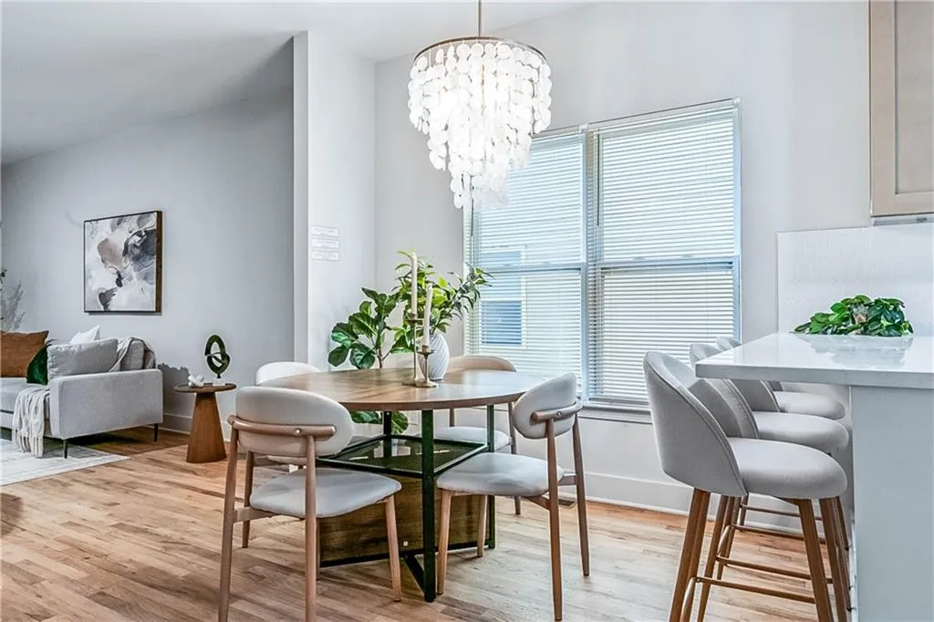 Dining space with light wood-type flooring and a chandelier