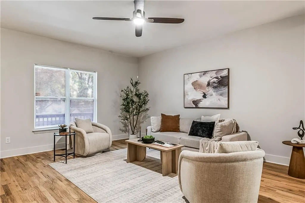 Living area with light wood finished floors and a ceiling fan
