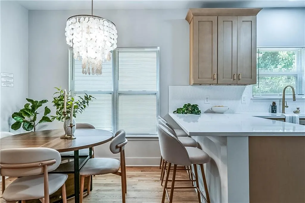 Dining space with light wood finished floors and a chandelier