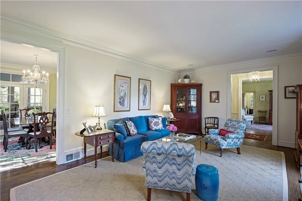 Living room flows to formal dining room.