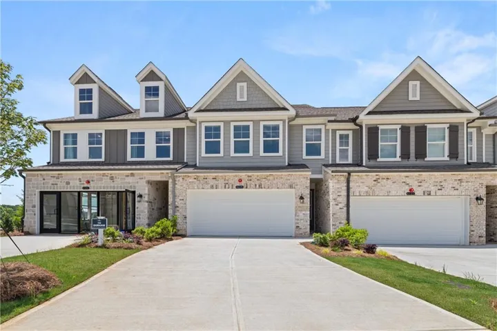 Modern townhome facade featuring a stone and siding exterior