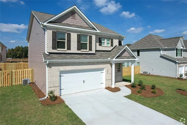 Craftsman inspired home featuring a front lawn, a garage, and cooling unit