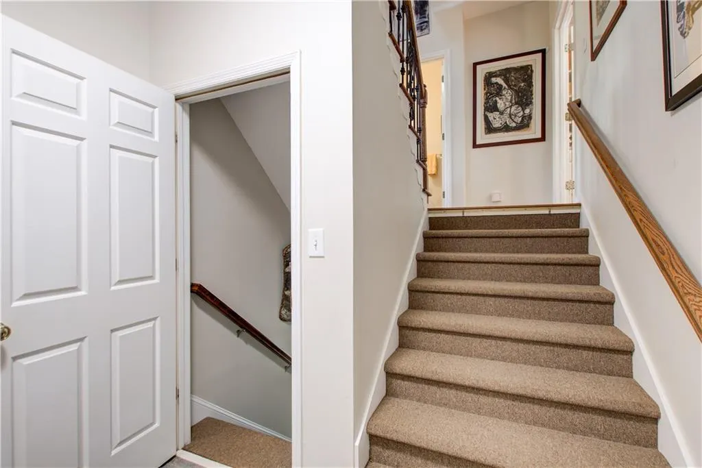 Stairway featuring carpet flooring and baseboards