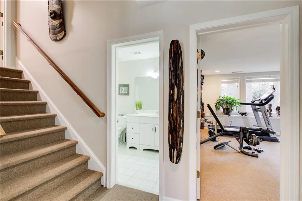 Staircase featuring tile patterned flooring and carpet flooring