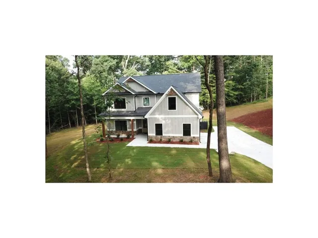 Two-story exterior with light gray siding and stone accents