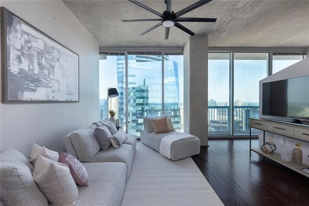 Living room with floor-to-ceiling windows frame stunning northeast-facing views of the Buckhead skyline.