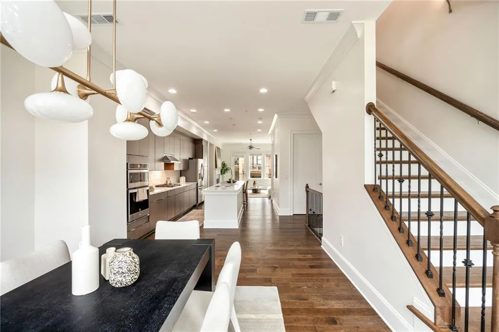 Dining room featuring stairway, dark wood finished floors, visible vents, and recessed lighting