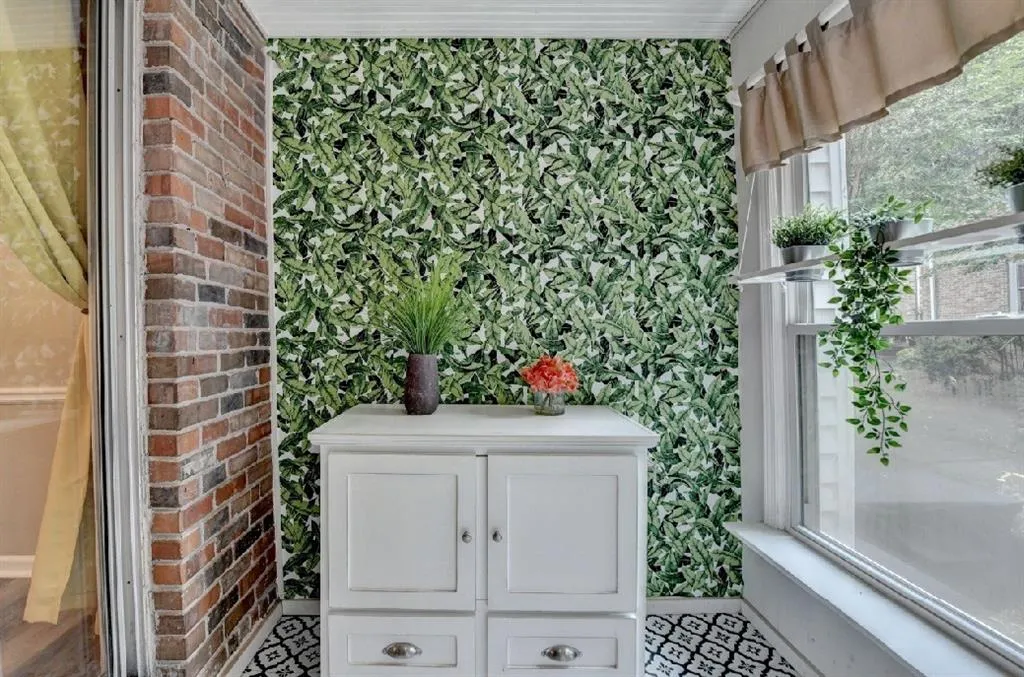 Bathroom with wallpapered walls and plenty of natural light