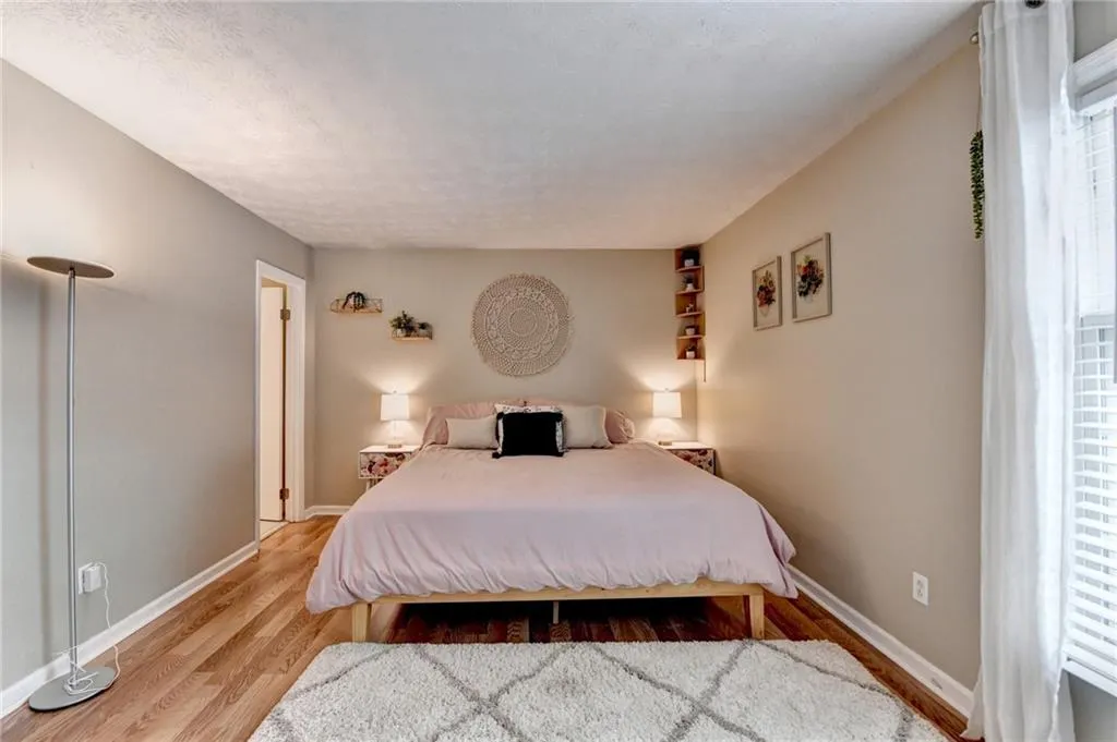 Bedroom featuring wood finished floors and baseboards