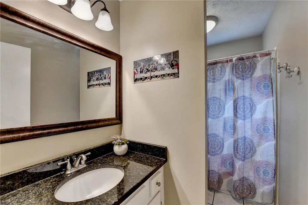 Full bathroom featuring vanity and curtained shower