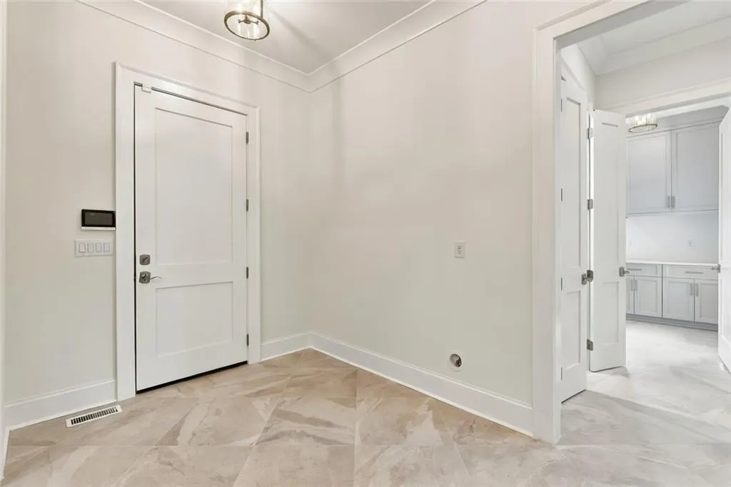 Exit to 3 car Garage, Pantry and Laundry