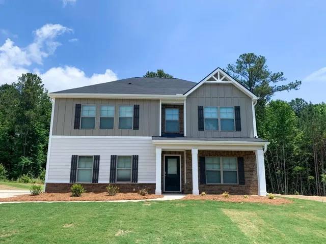 Two-story residence featuring a covered entry porch supported by white columns