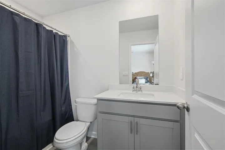 Modern vanity with a light gray finish, white countertop, and integrated sink
