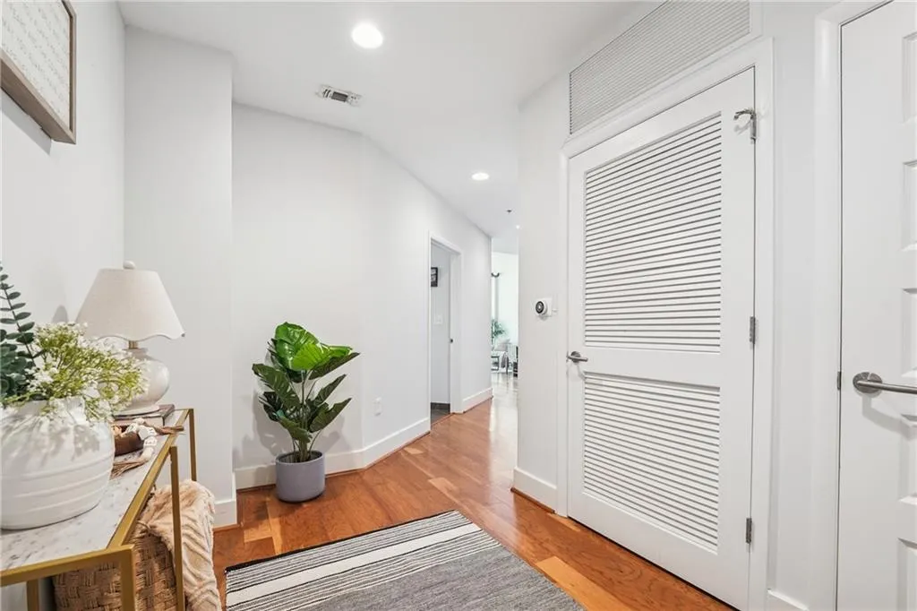 Hall with recessed lighting, light wood-type flooring, and baseboards
