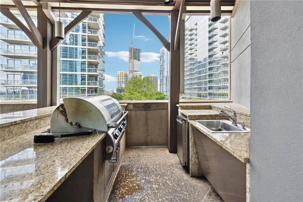 View of patio with a view of city and exterior kitchen