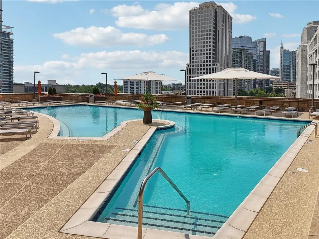 Community pool featuring a patio and a view of city