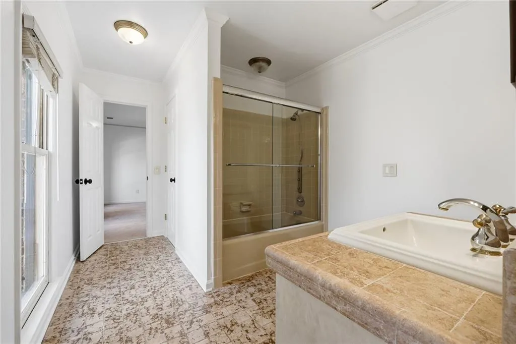 Jack and Jill Bathroom connecting the other two bathrooms with ceramic tile and tub/shower.