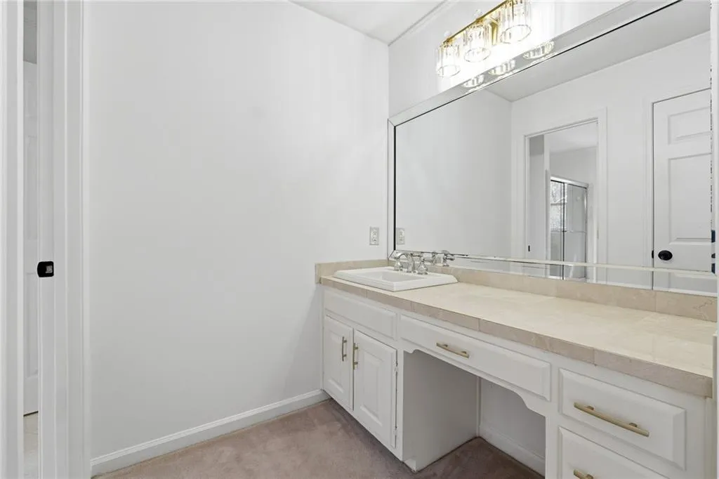 The second vanity of this jack and jill bathroom with designer light and luxe mirror.