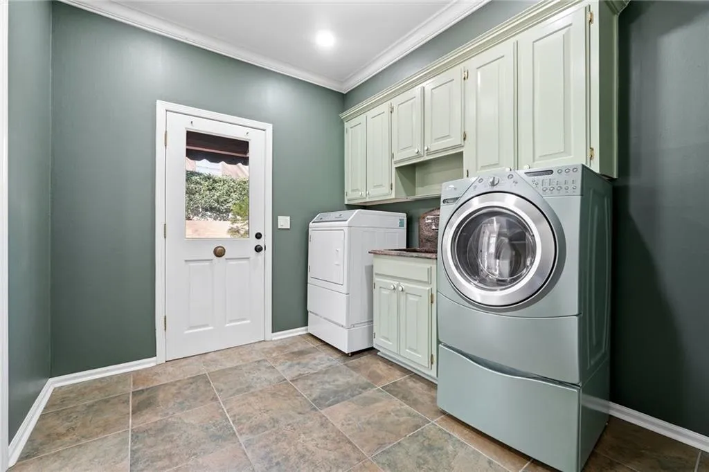The laundry room is on the main floor, and with this sink and entrance on the side of the house would make a great mudroom.