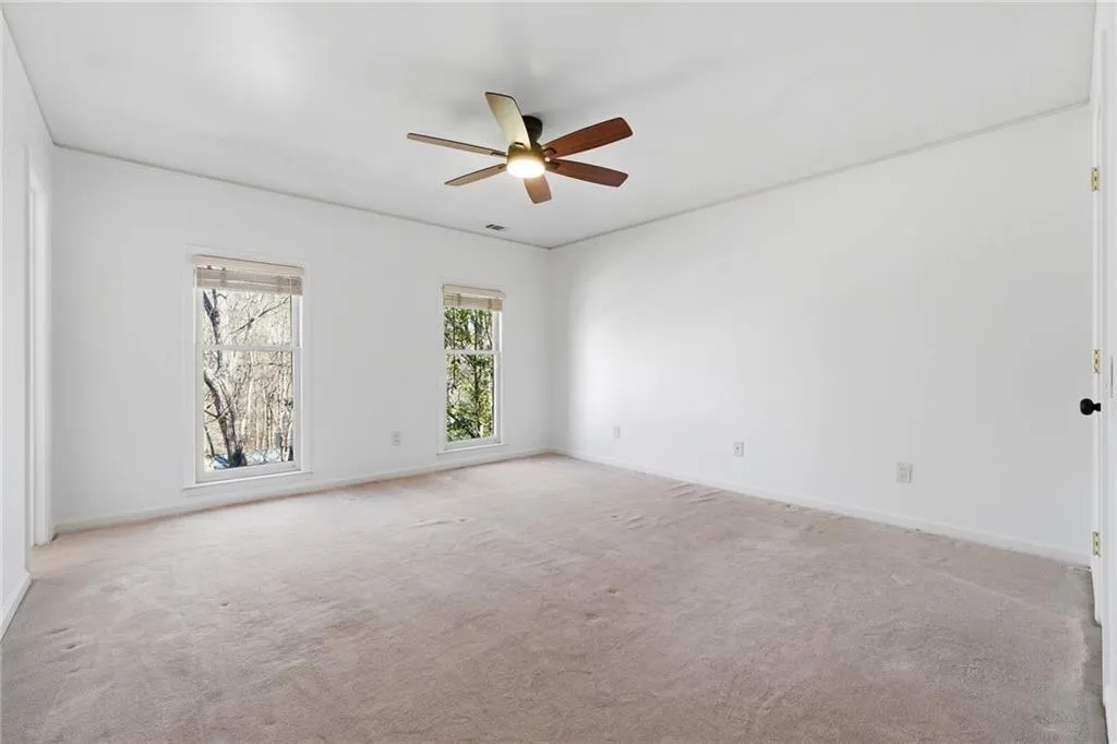 Auxiliary Bedroom #1 with luxe plush carpet and new fan.