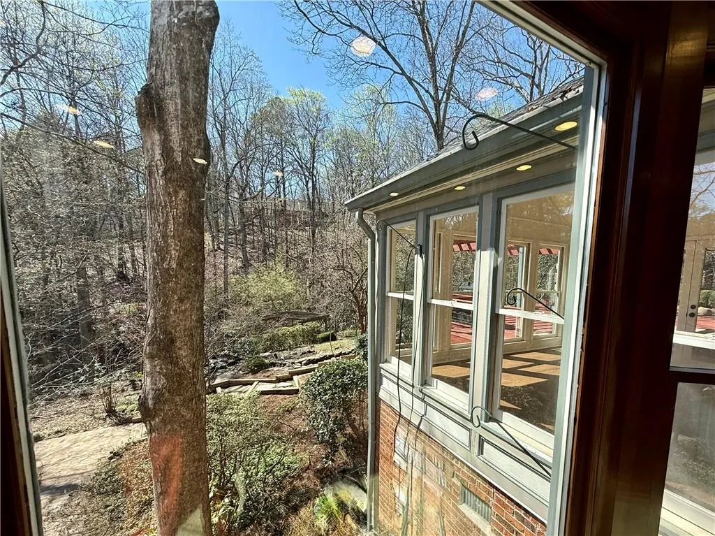 Another view of the sunroom as it overlooks the nature-filled backyard.