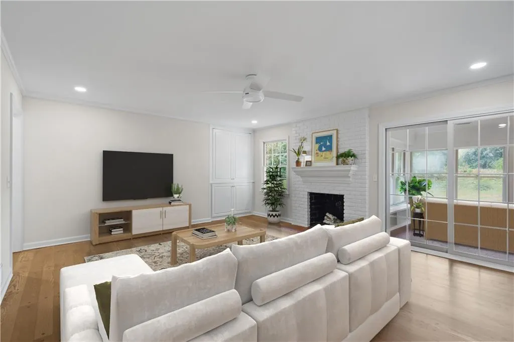 French doors from family room to sunroom. Virtually staged