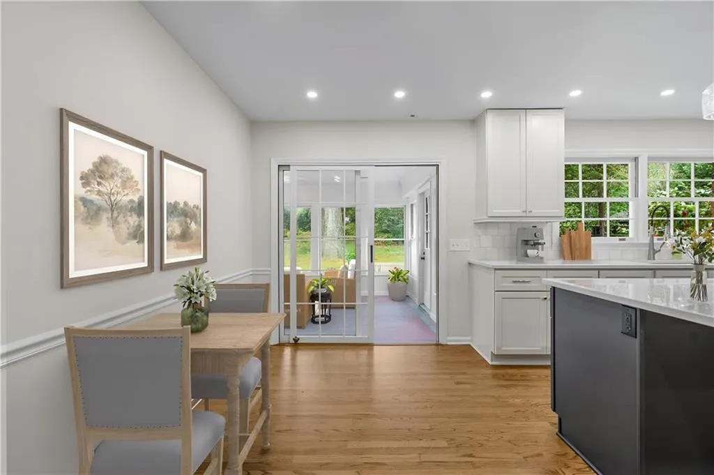 Kitchen view of sunroom. Virtually staged