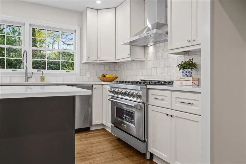 All stainless appliances with tiled backsplash