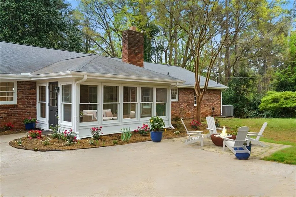 Back entry with the perfect place for a firepit on the stone patio