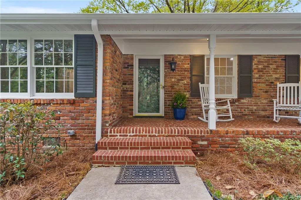 A true beauty with a welcoming rocking chair front porch