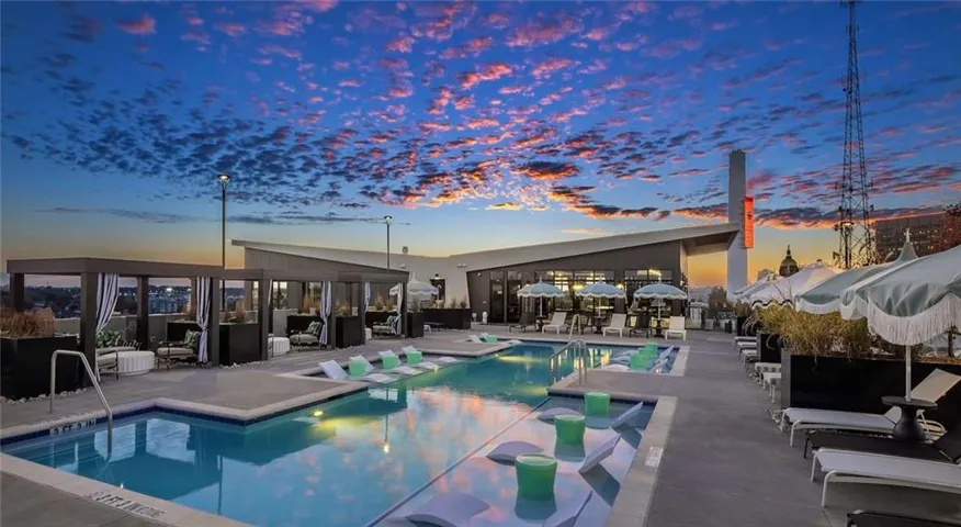 Pool at dusk featuring a patio and an outdoor pool