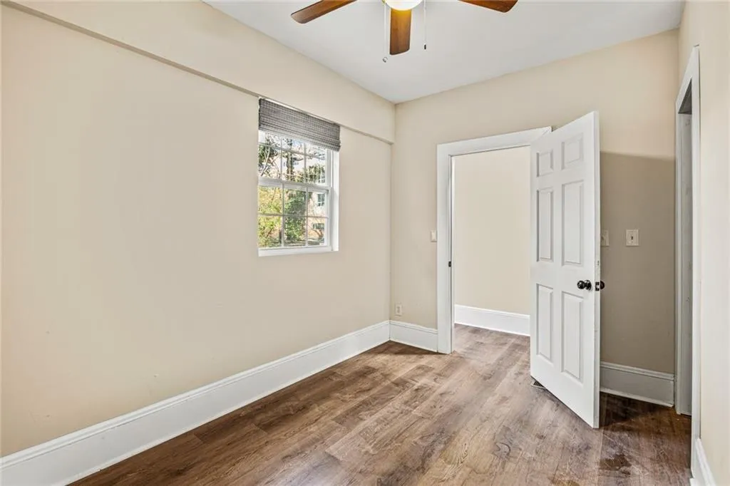 Unfurnished bedroom with wood finished floors and a ceiling fan