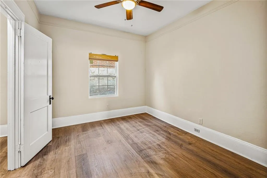 Unfurnished room with light wood finished floors and a ceiling fan