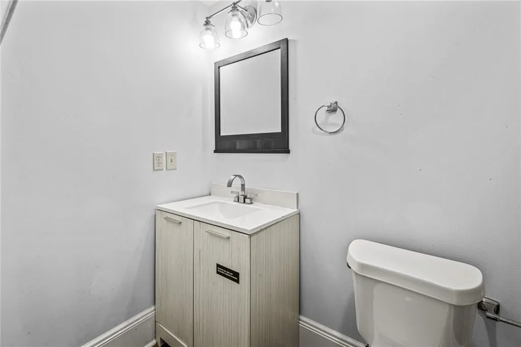 Half bath featuring vanity and toilet