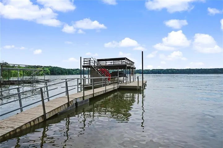Private boat dock featuring a boat lift with an upper deck. Located on the open water. Seller states there is 15' of water under the dock at full pool.