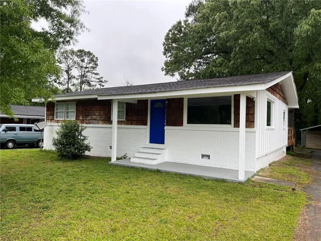 White brick facade with wood shake siding accents