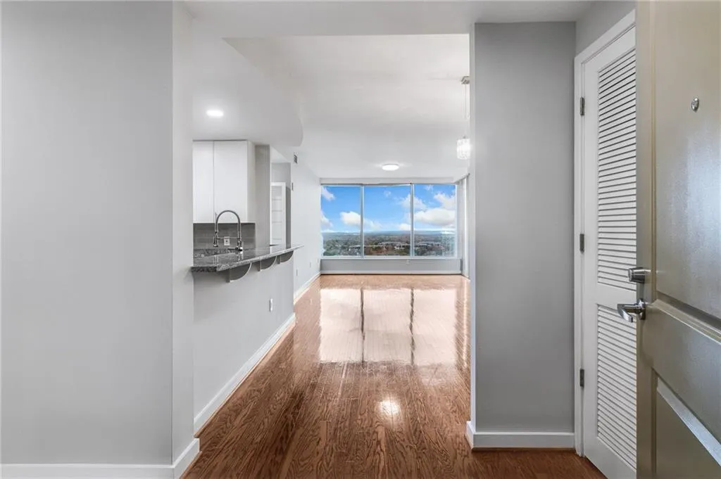 Hallway featuring baseboards and wood finished floors