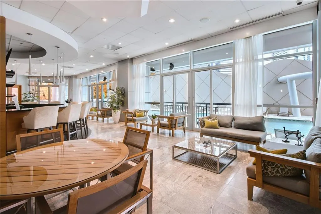 Dining area with plenty of natural light, a high ceiling, and a paneled ceiling