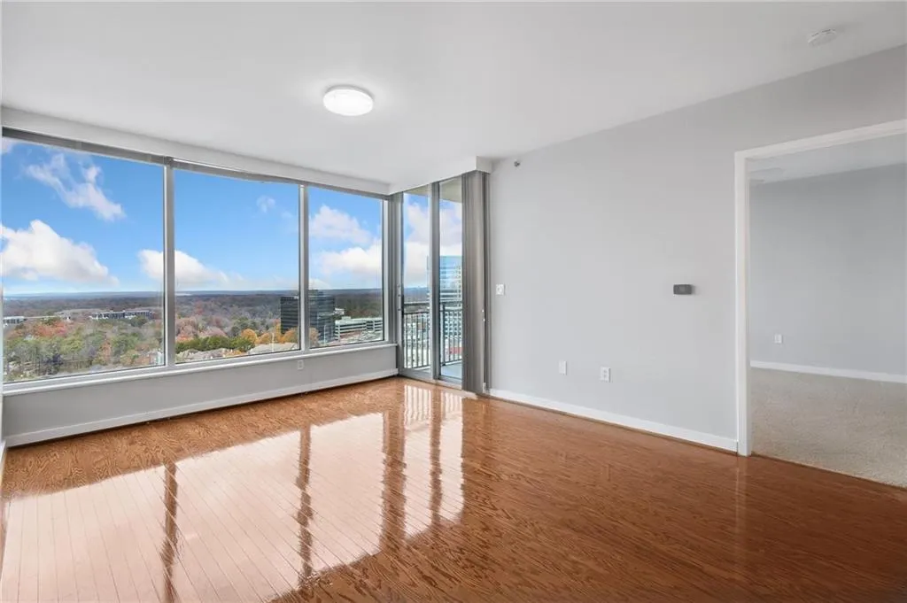 Unfurnished room featuring wood finished floors and baseboards